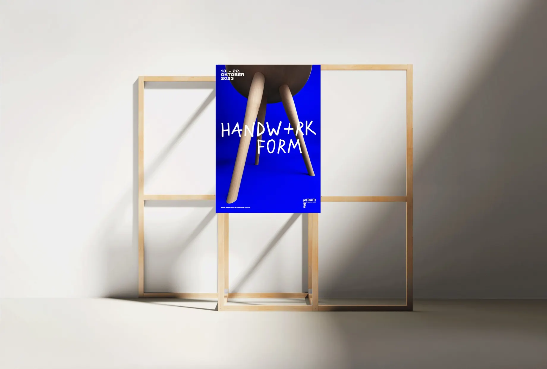 Blue Handwerk+Form poster on a wooden stand